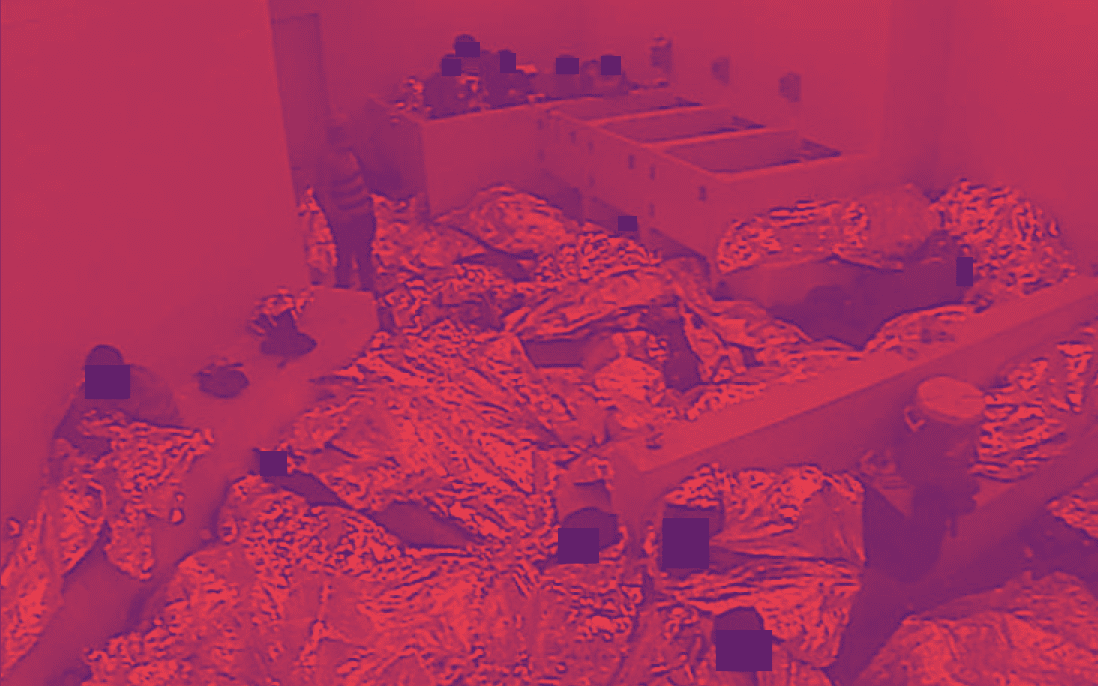 A filtered image of people cramped together in detention with thin foil blankets