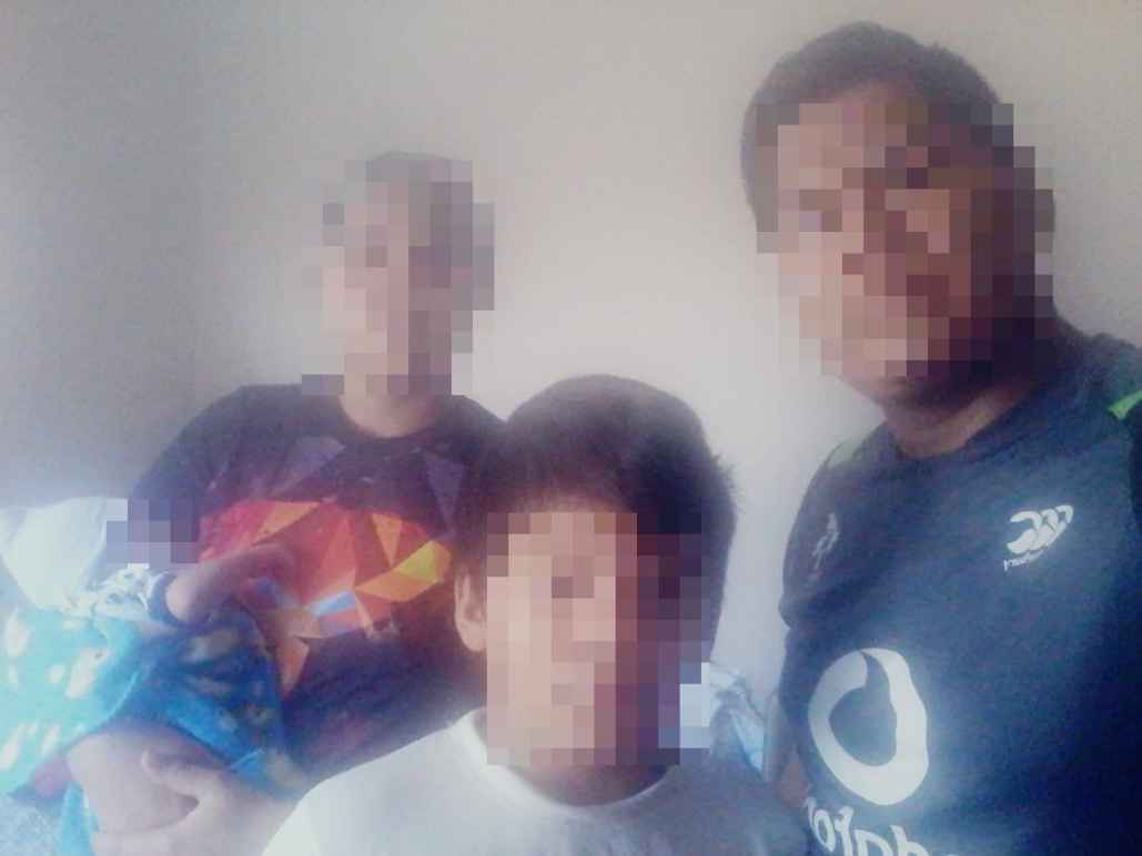 Image of a family with pixelated faces to protect their identity.